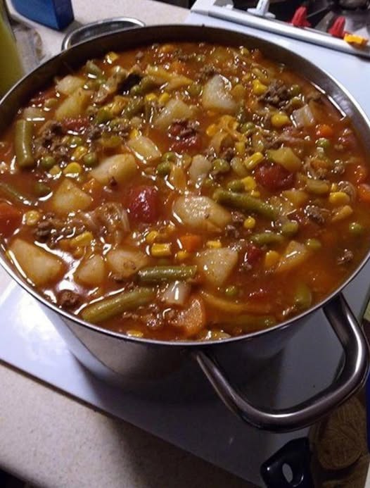 Ingredients 1 1/2 lbs beef stew meat 2 1/2 Tbsp olive oil, divided Salt and freshly ground black pepper 1 3/4 cups chopped yellow onion (1 large) 1 1/4 cups peeled and chopped carrots (3 medium) 1 cup chopped celery (3 medium) 1 1/2 Tbsp minced garlic (4 cloves) 8 cups low-sodium beef broth or chicken broth 2 (14 oz.) cans diced tomatoes 1 1/2 tsp dried basil 1 tsp dried oregano 1/2 tsp dried thyme 1 lb red or yellow potatoes, chopped into 3/4-inch cubes 1 1/2 cups (5 oz.) chopped green beans (trim ends first) 1 1/2 cups frozen corn 1 cup frozen peas 1/3 cup chopped fresh parsley How To Make Best Ever Easy Vegetable Beef Soup Heat 1 Tbsp olive oil in a large pot over medium-high heat. Dab beef dry with paper towels, season with salt and pepper then add half of the beef to pot and brown about 4 minutes, turning halfway through. Transfer to a plate add another 1/2 Tbsp oil to pot and repeat process with remaining half of beef. Add another 1 Tbsp oil to now empty pot then add onions, carrots, and celery then saute 3 minutes, add garlic saute 1 minute longer. Pour in broth, tomatoes, browned beef, basil, oregano, thyme and season with salt and pepper. Bring to a boil then reduce heat to low, cover and simmer, stirring once or twice throughout, for 30 minutes. Add potatoes then continue to simmer, covered, 20 minutes (you can also add green beans with potatoes if you like them very soft). Stir in green beans and simmer 15 minutes longer, or until all of the veggies and beef are tender. Pour in corn and peas and simmer until heated through, about 5 minutes. Stir in parsley and serve warm.